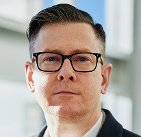 Portrait of Alexander Hughes, chief executive of a cryptocurrency trading company